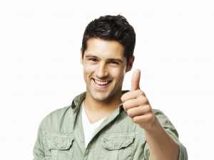 Handsome young man gives a thumbs up to the camera. Square shot. Isolated on white.